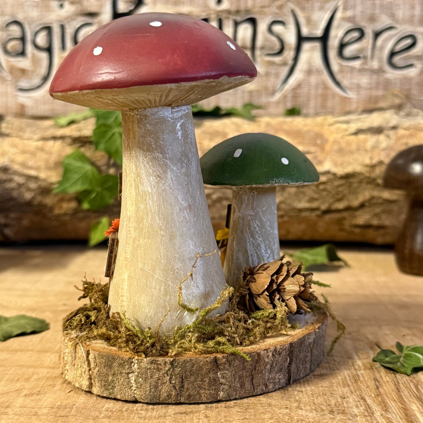 Wander into a whimsical woodland with our Folk Art Mushroom Two Cottages (Tall) — a delightful pair of hand painted fairy houses inspired by rustic village life and the charm of springtime meadows. Each tall mushroom cottage is adorned with bright folk art patterns, floral details, and earthy tones that bring a sense of storybook enchantment to your home.