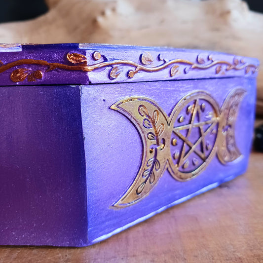 Add a touch of mystical charm to your home with this beautiful Purple Triple Moon Jewellery Box. Featuring the symbolic Triple Moon design, this enchanting decorative box celebrates feminine energy, lunar cycles and spiritual transformation. Finished in rich purple and gold, it makes a striking addition to any altar, bedside table or sacred space.