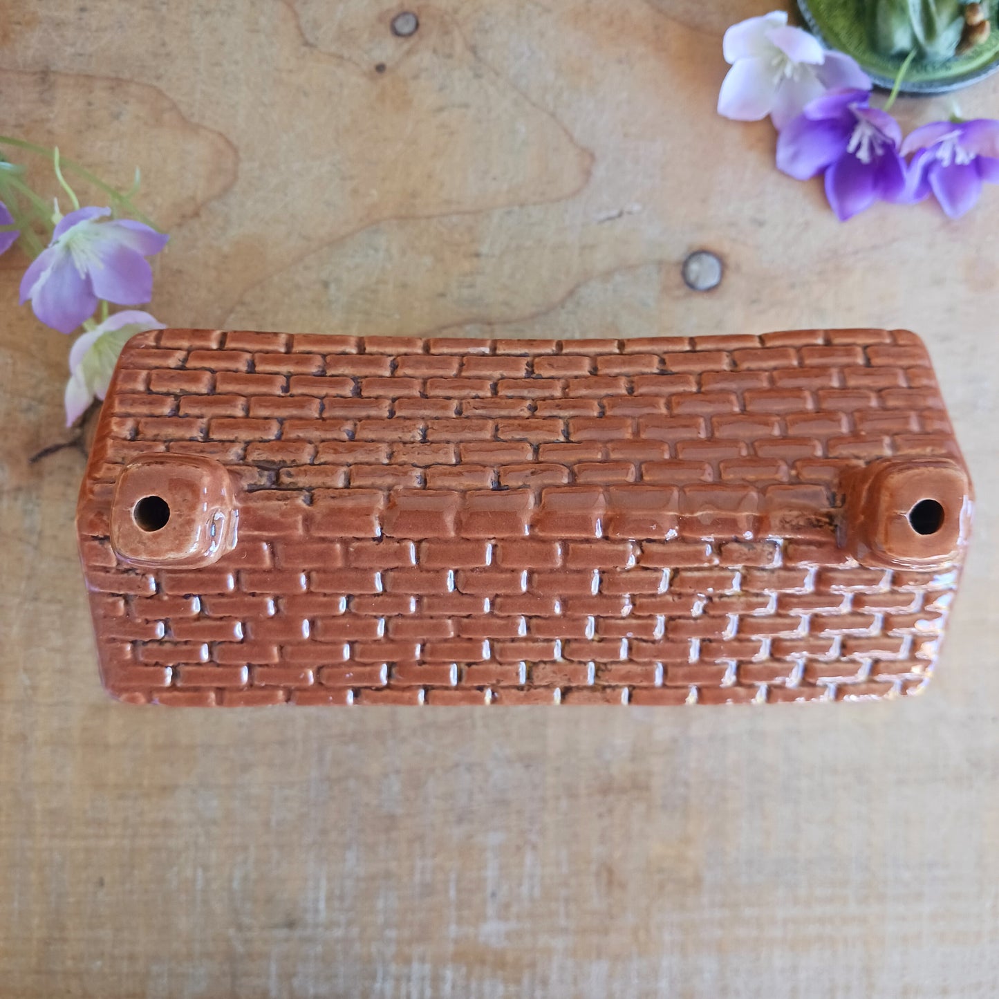 Whispers travel by candlelight from this Village Pottery Post Office tealight house, where tiny windows glow like messages carried between realms. Crafted from ceramic and measuring 12x15x7cm, this enchanting piece brings warmth and quiet magic to your sacred space.