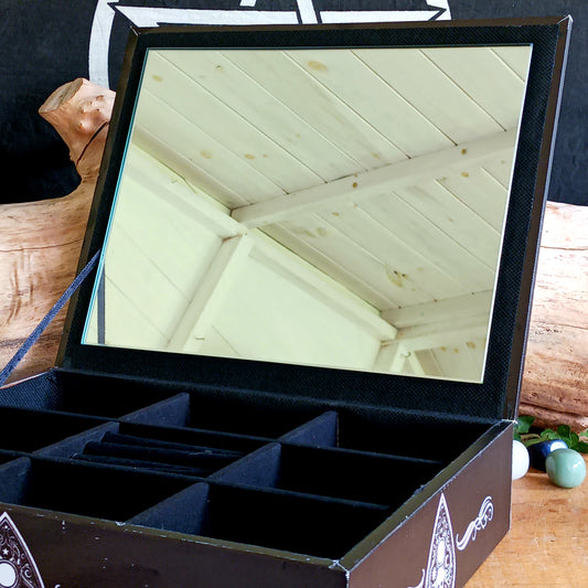 Add a touch of gothic and vintage occult style to your dressing table with this large spirit board jewellery box. Designed with a striking black background, white baroque artwork and traditional spirit-board-inspired details, it makes an unusual storage piece for anyone drawn to mystical and alternative décor.