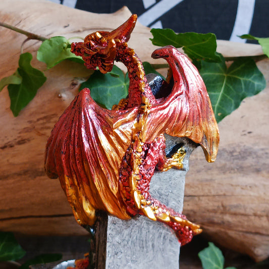 Bring a touch of mythical magic to your home with the Light of the Dragon Red Ornamental Tealight Holder. Featuring an enchanting red dragon coiled around a tombstone-style base, this intricately detailed candle holder is perfect for fantasy lovers and collectors of unusual home décor.