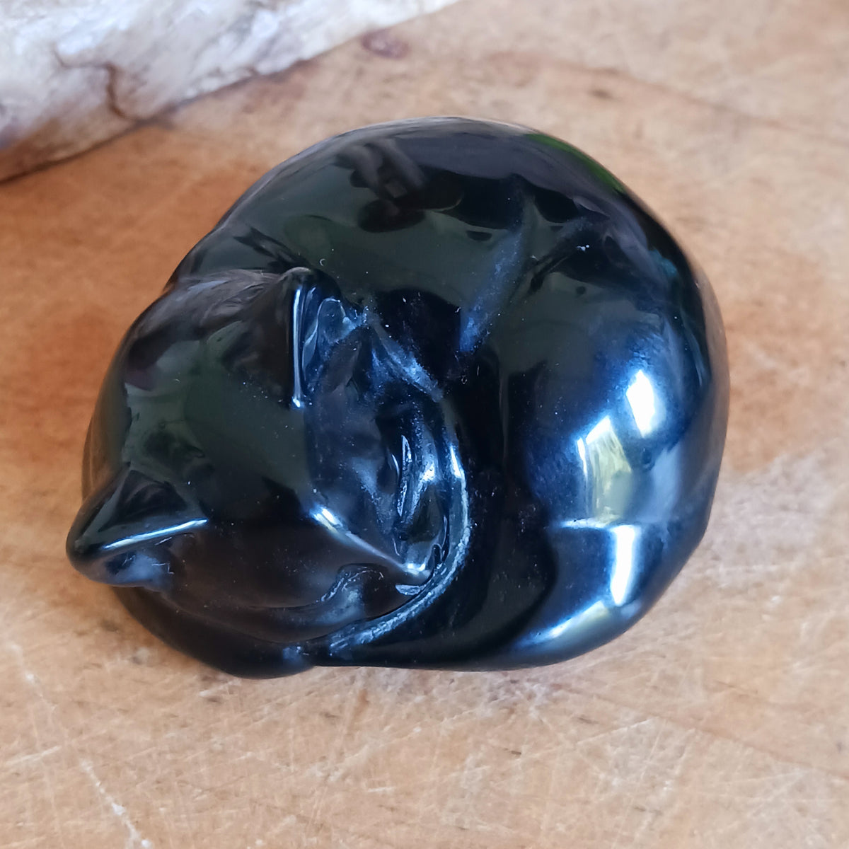 Bring a sense of calm, comfort and protection into your home with this beautifully carved Black Obsidian Sleeping Cat. Expertly shaped into a peaceful curled pose, this charming gemstone carving combines the graceful symbolism of a sleeping cat with the grounding beauty of natural black obsidian.