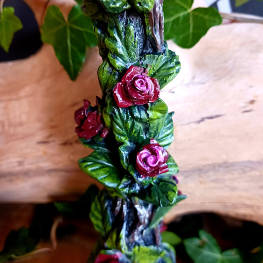 Add a touch of dark elegance to your home with the Scarlet Rose Gothic Candlestick Holder. Beautifully crafted with a stone pillar design, this striking ornament features intricate red roses and green vegetation, creating a mysterious gothic aesthetic that makes a statement in any room.