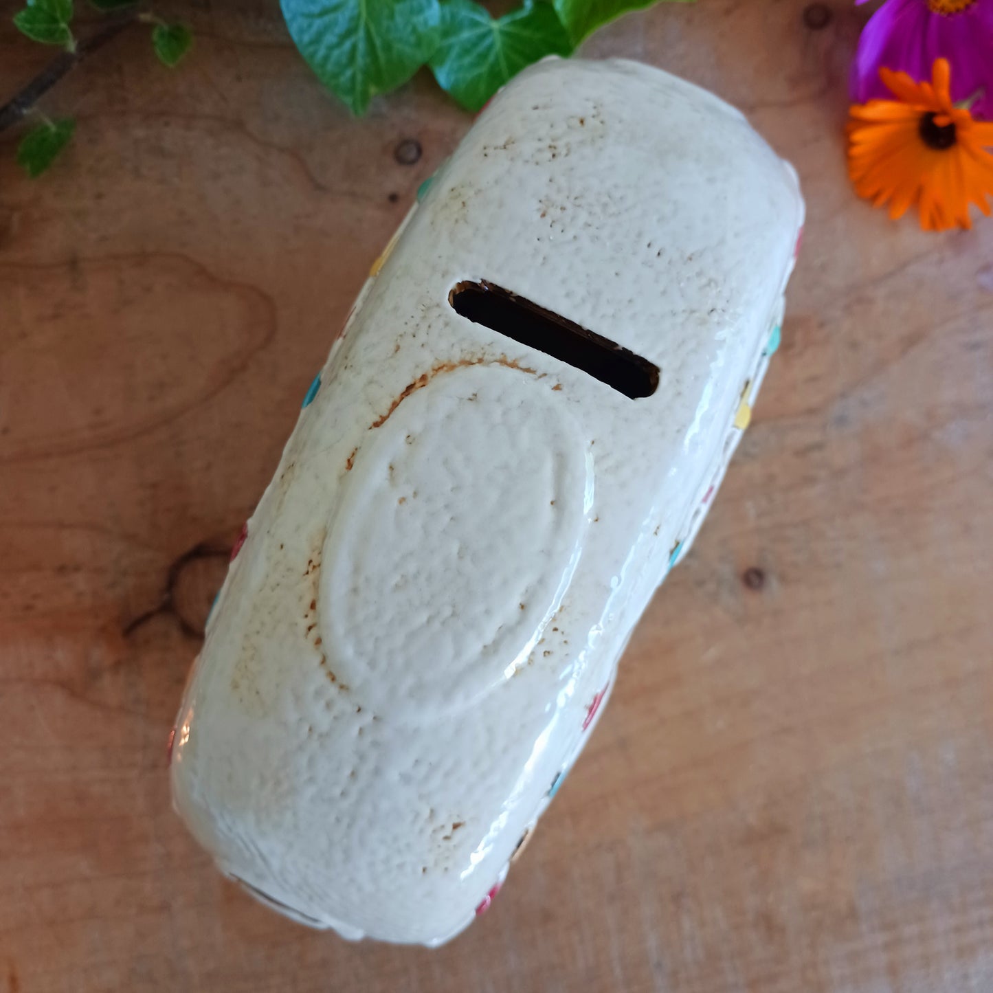 From the enchanted lanes of Village Pottery comes this Aqua Caravan Money Box, a charming ceramic treasure crafted for dreamers and wanderers alike. Measuring 13.5 x 18.5 x 6.5 cm, this delightful piece captures the spirit of adventure with its soft aqua glaze, vintage caravan design, and hand-painted detailing that feels kissed by fairy dust.