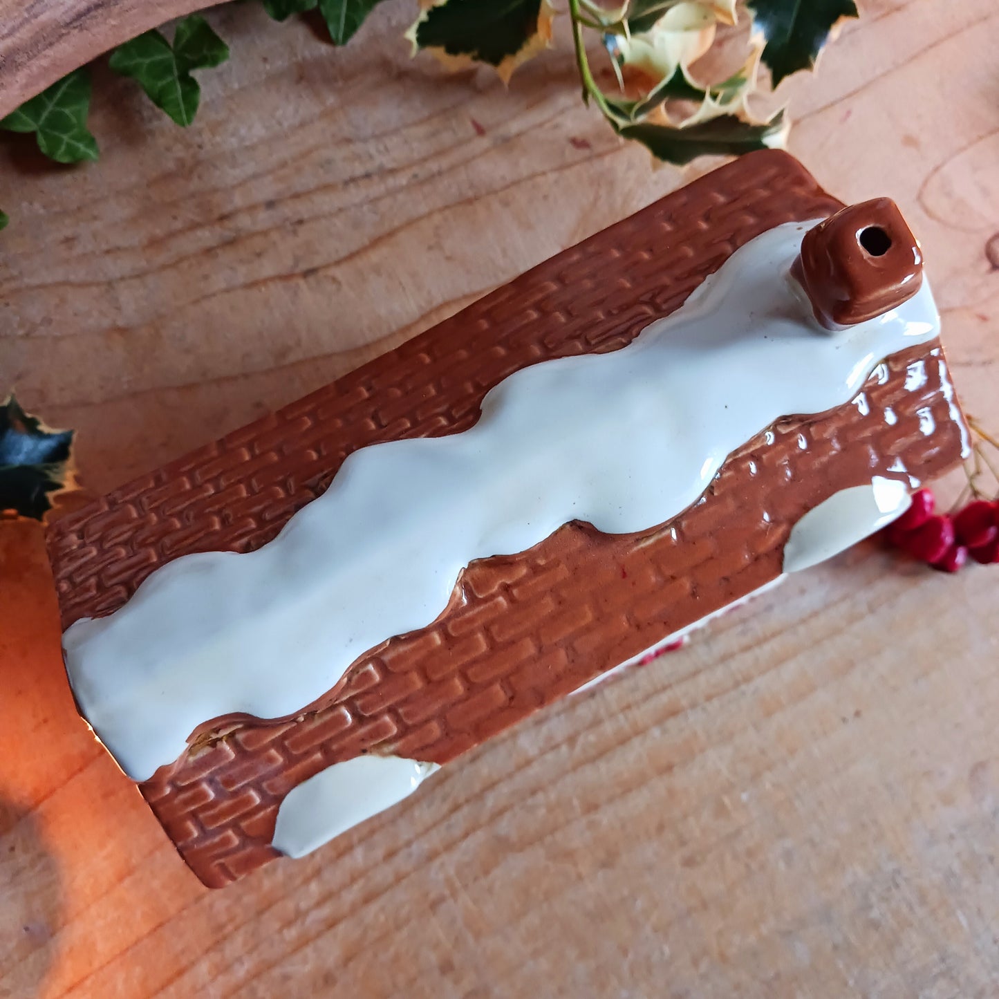 Bring nostalgic festive charm to your home with our Christmas Toy Shop Ceramic Tealight Holder, handcrafted in the Village Pottery workshop. This detailed tealight house captures the magic of an old-world toy shop on a snowy winter’s evening.