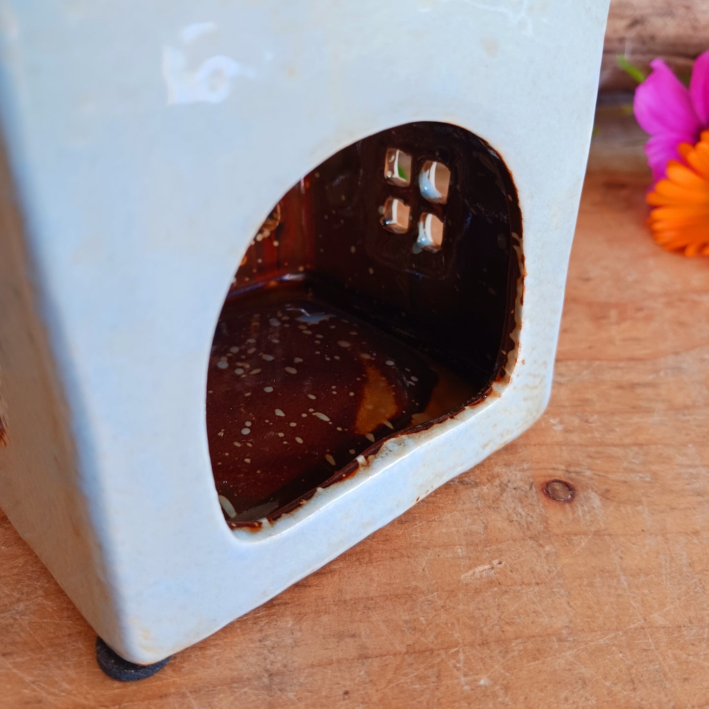 Welcome a touch of storybook charm into your home with the Village Pottery Village Stores Tealight Holder, a handcrafted ceramic delight glowing with the warmth of simpler times. Measuring 15.5 x 9.5 x 8 cm, this quaint miniature shop captures the heart of an old-fashioned village, complete with detailed windows, rustic roof tiles, and painted signage that evokes cosy nostalgia.