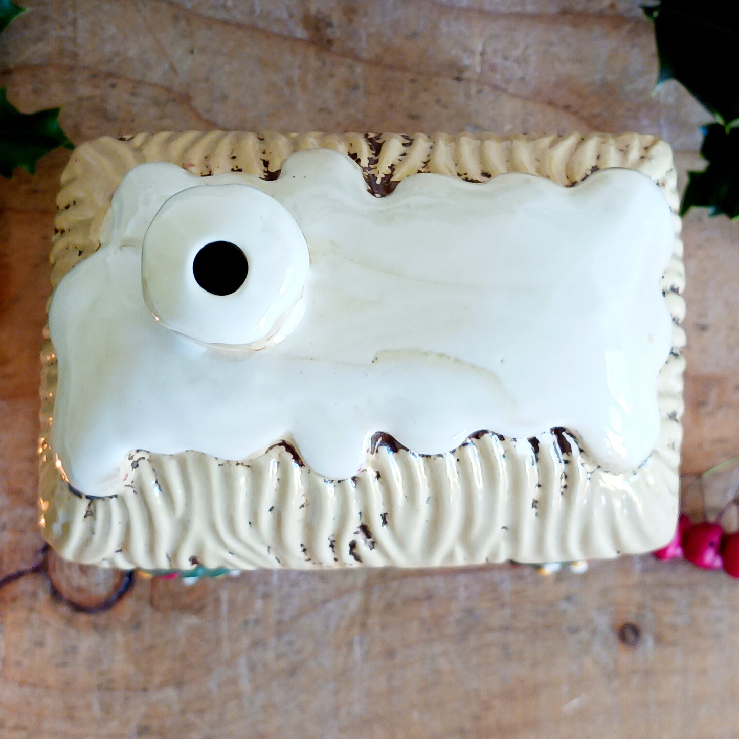 Bring timeless festive charm into your home with the Village Pottery Christmas Thatched Roof House Tealight Holder, a handcrafted ceramic cottage glowing with the spirit of the season. Measuring 17 x 12.5 x 8.5 cm, this enchanting piece captures the essence of a peaceful winter’s night — where golden candlelight flickers through snowy windows beneath a soft thatched roof.