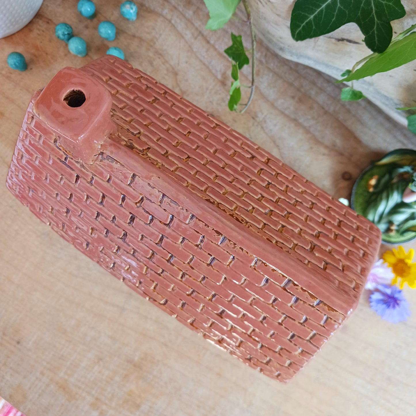 Step into a world of whimsy with this beautifully detailed Village Pottery Sweet Shop Tealight by Shudehill. Part of the beloved collectible village series, this miniature ceramic sweet shop is designed to hold a tealight candle, casting a warm, inviting glow through its charming windows and door.