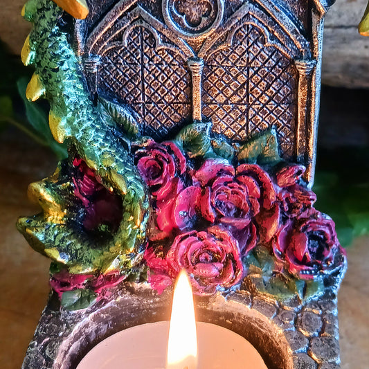 Bring a touch of mythical magic to your home with the Light of the Dragon Green Ornamental Tealight Holder. Featuring an enchanting green dragon coiled around a tombstone-style base, this intricately detailed candle holder is perfect for fantasy lovers and collectors of unusual home décor.