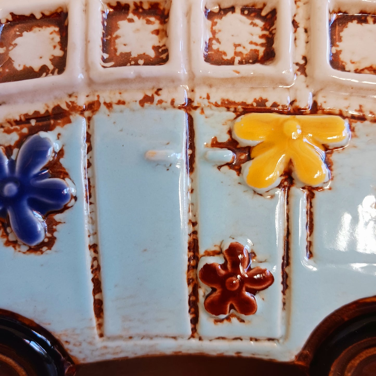 From the enchanted lanes of Village Pottery comes this Aqua VW Campervan Money Box, a charming ceramic treasure crafted for dreamers and wanderers alike. Measuring 11 x 18.5 x 10cm, this delightful piece captures the spirit of adventure with its soft aqua glaze, vintage VW Campervan design, and hand-painted detailing that feels kissed by fairy dust.