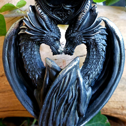 Add a touch of mythical drama to your home with the Dark Heart Candle Holder, a beautifully crafted fantasy ornament featuring two dragons lovingly positioned head-to-head to hold a single tealight or pillar candle.