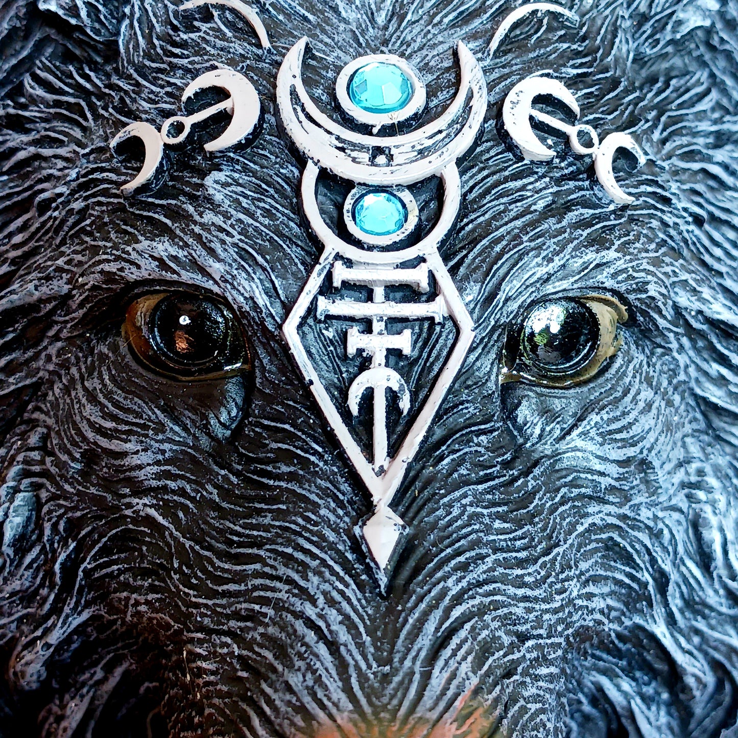 Add a touch of mystical charm to your entrance with this striking Wolf Moon door knocker. This beautifully crafted piece is cast in high-quality resin and expertly hand-painted. The wolf's watchful eyes and detailed design create a captivating focal point, adding character to your home's exterior. The solid metal ring provides a clear, resonant knock.