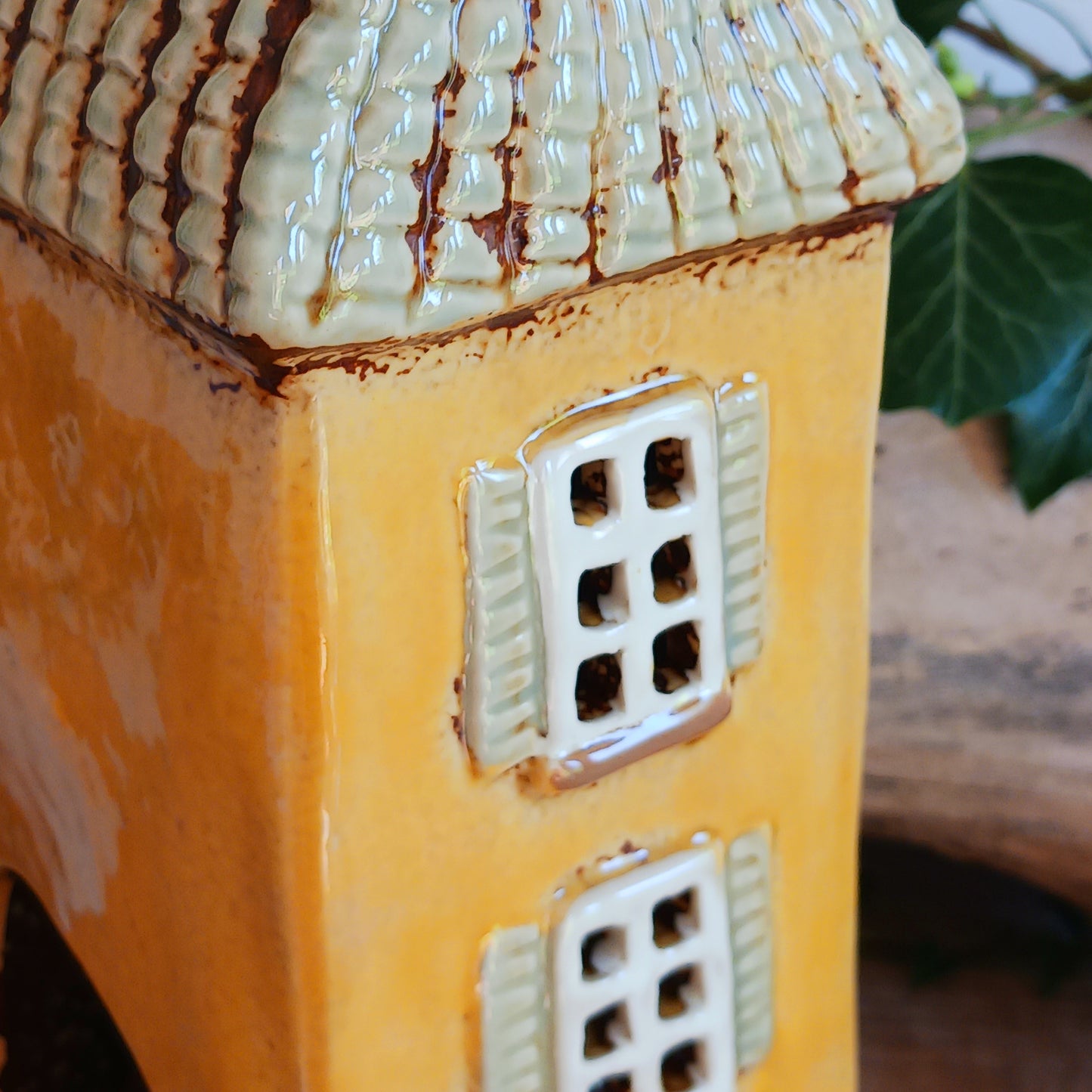 A beautiful and tall Garden House | Shutter Tealight Holder to add to your Village Pottery collection. This holder is handmade from ceramic with a glazed finish with lovely shutters on the windows of the house.