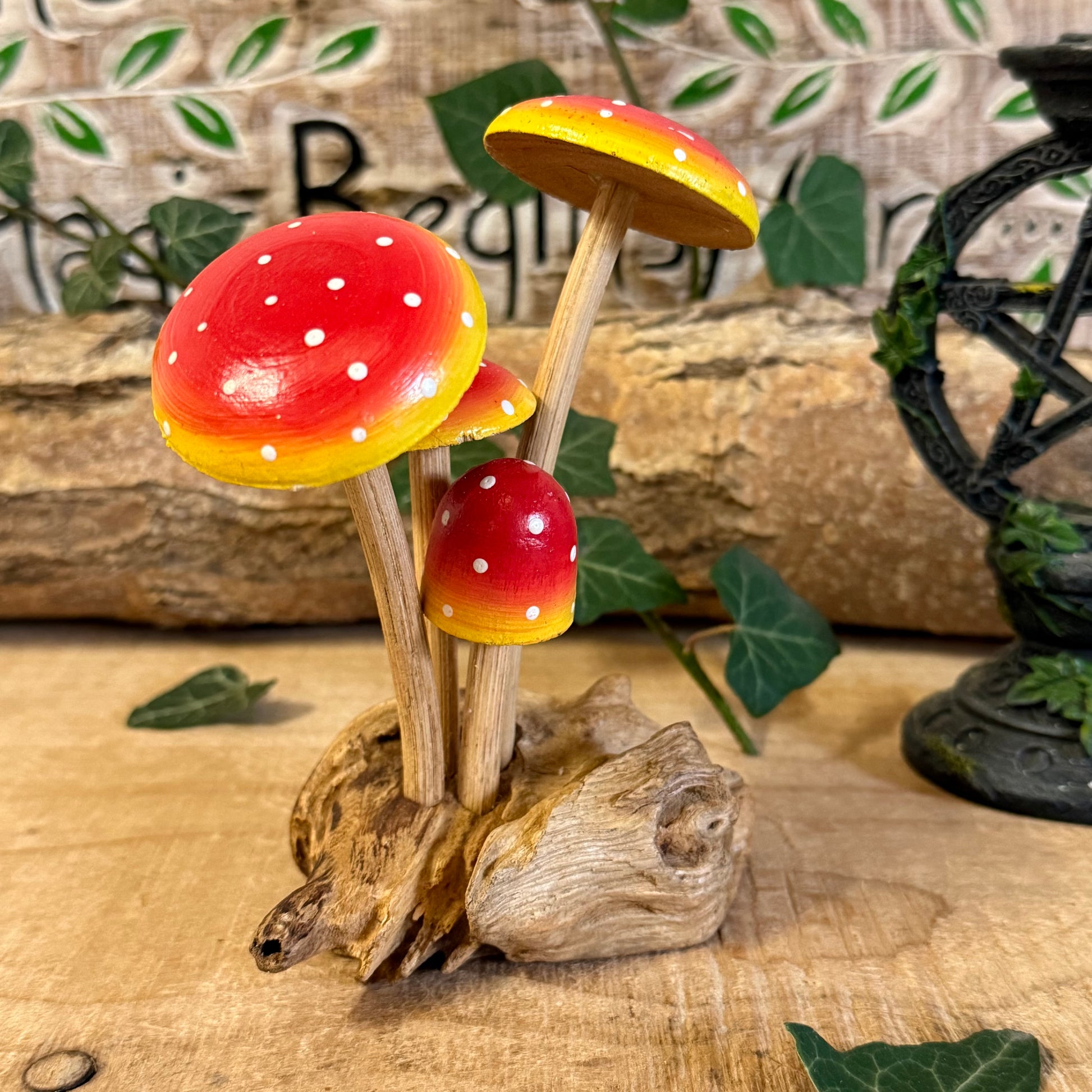 Hand carved red wooden mushrooms on rustic base. Perfect for fairy gardens, cottage-style décor, and whimsical woodland displays in any home.