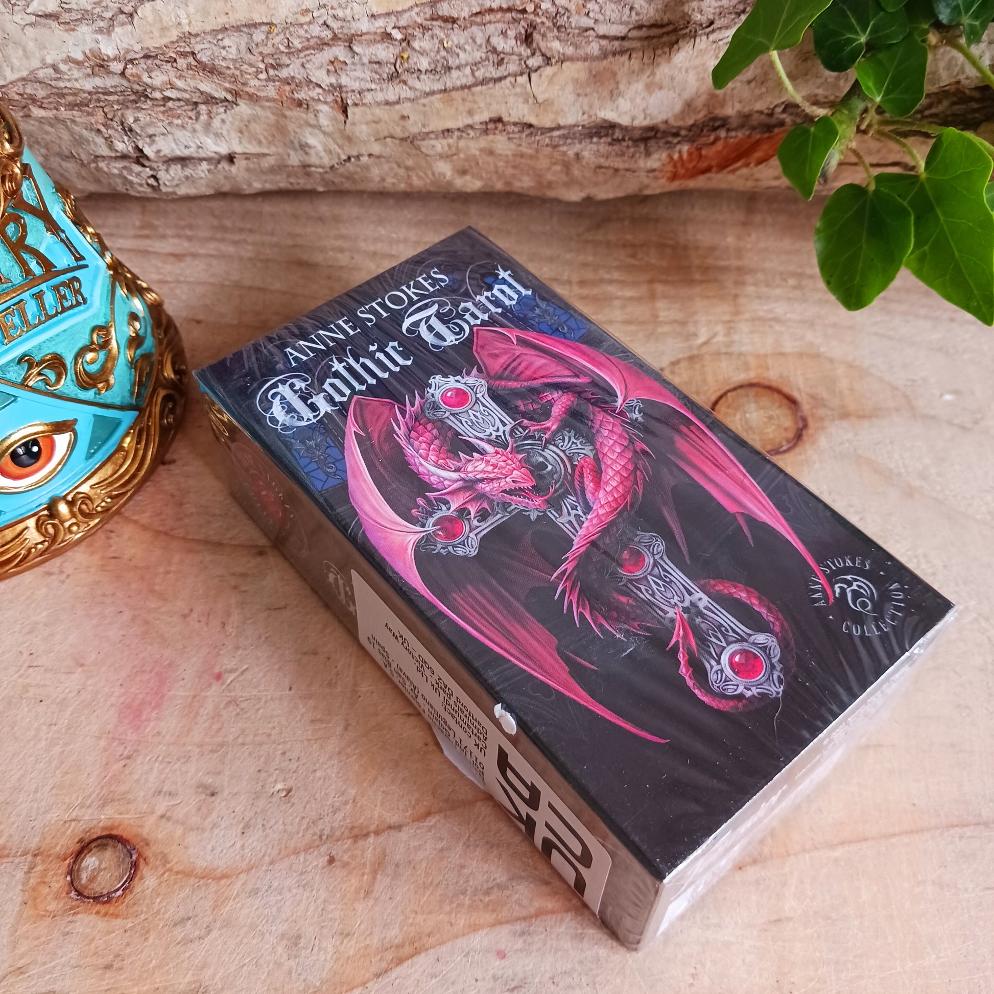 This exquisitely crafted deck offers a captivating gothic twist on the traditional Rider-Waite-Smith suits. The wands are themed to mighty dragons. Cunning vampires have replaced the cups. Skeletons stand in for pentacles, and the swords have become angels. 