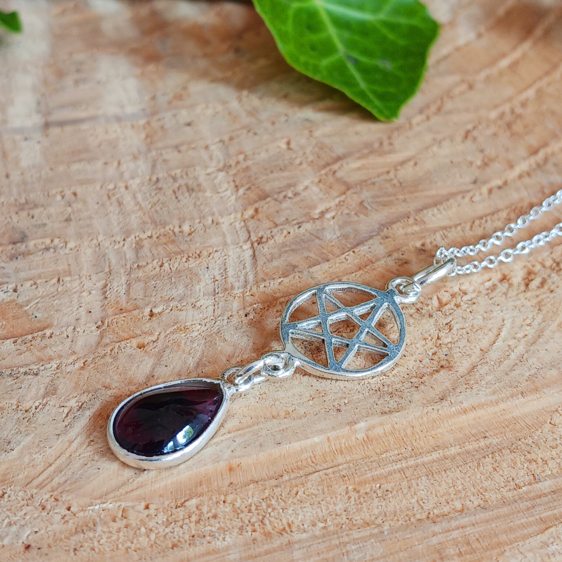 Beautifully handcrafted pentagram pendant in solid silver with a teardrop Garnet gemstone.&nbsp;&nbsp;   According to the Greek mathematician and philosopher Pythagoras, the pentagram&nbsp;represents the elements: Earth, Air, Fire and Water, with Spirit placed on the top. His followers, the Pythagoreans, saw it as mathematical perfection, which would later come to be known as the Golden ratio.