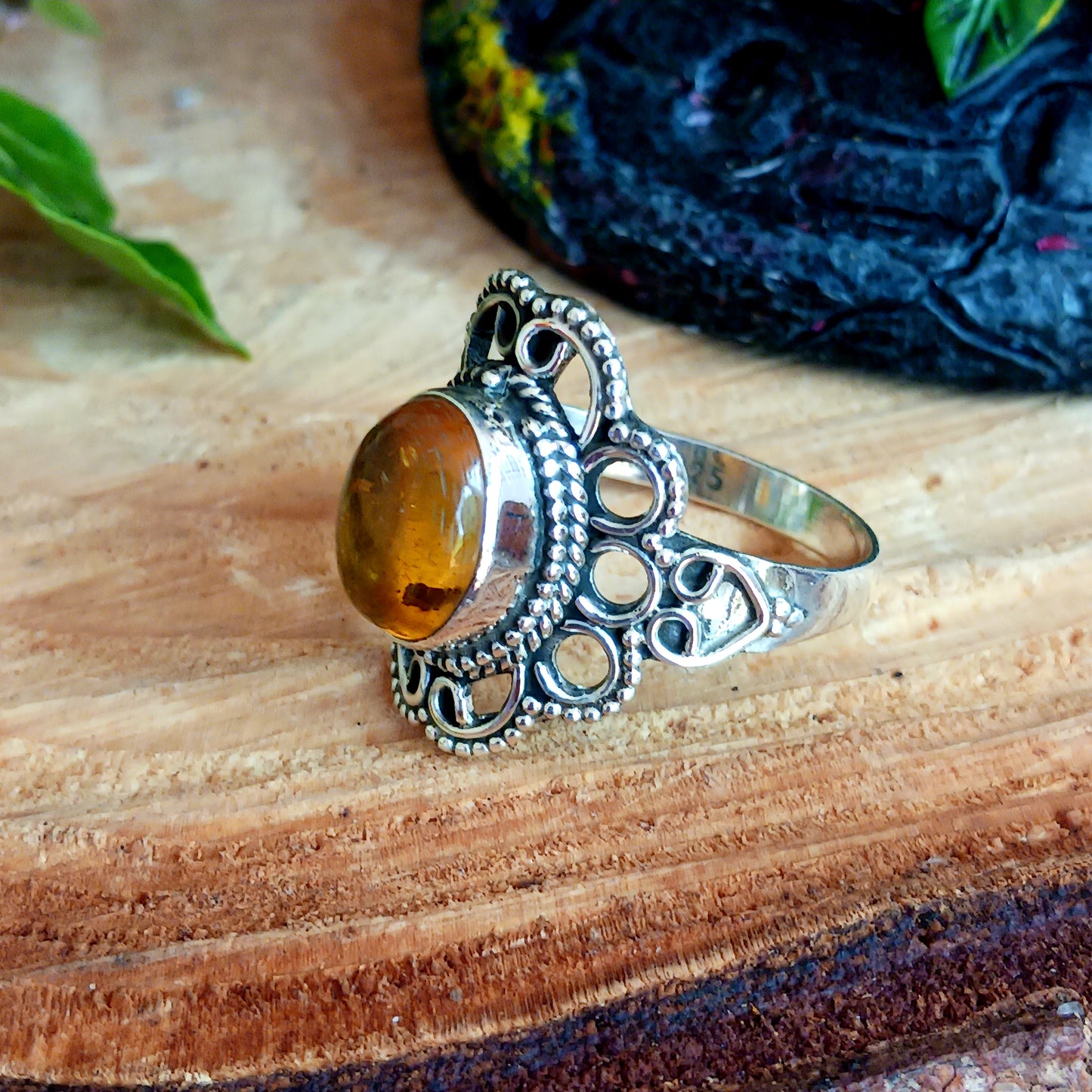 This beautiful ring features an intricate Boho Filigree coiling around the Stone held in the centre, which is an almond-shape Amber gemstone in a wonderful translucent Amber Colour.   The shank is slightly oxidized to show detail and looks lovely with the Amber brightness. A little bit of Gothic with a boho twist!