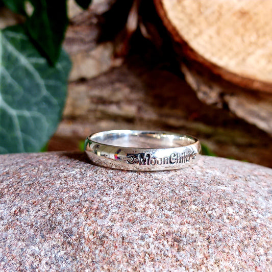 These elegant and sophisticated Sterling Silver Band rings have the words MoonChild engraved in Gothic lettering on the front.  Being a Moonchild can be a way of expressing a deep appreciation for the natural world, the cycles of life, and the mystical or spiritual aspects of the moon.  Made from Sterling Silver and available in three sizes (see below), these bands make a lovely gift for someone special.  Gifted in a black velvet pouch. &nbsp;