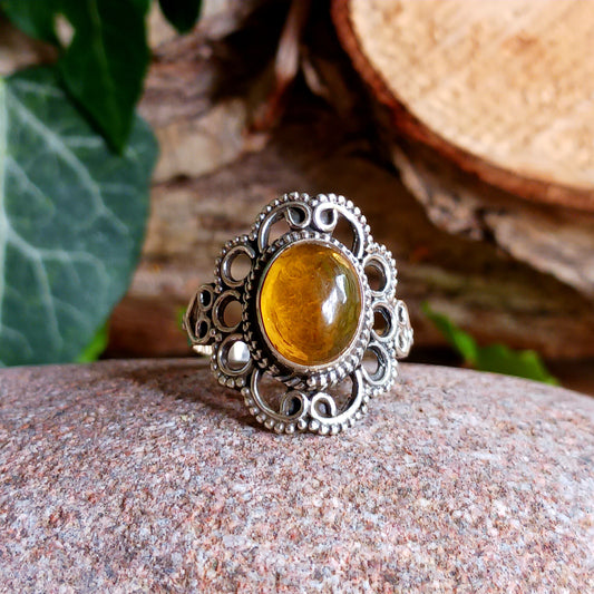 This beautiful ring features an intricate Boho Filigree coiling around the Stone held in the centre, which is an almond-shape Amber gemstone in a wonderful translucent Amber Colour.   The shank is slightly oxidized to show detail and looks lovely with the Amber brightness. A little bit of Gothic with a boho twist!