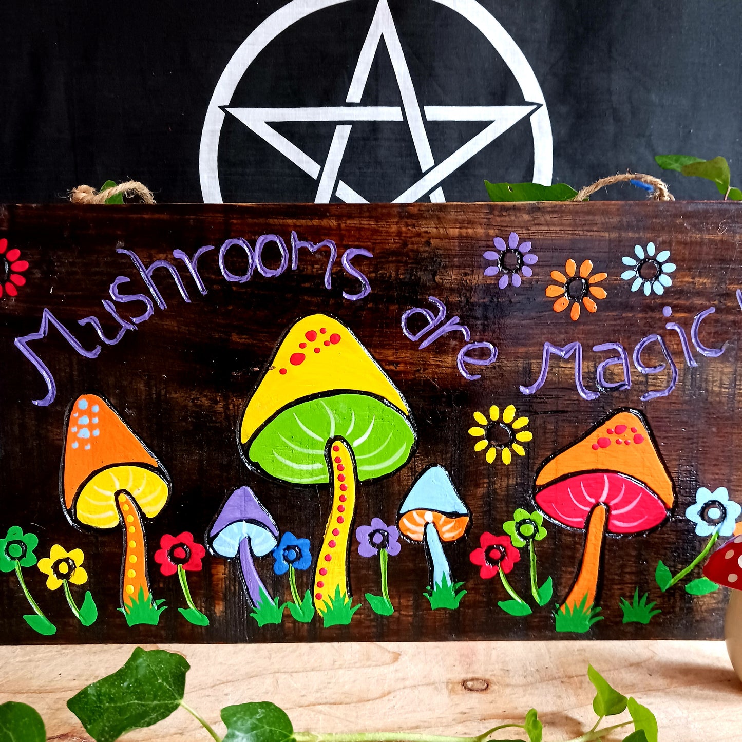 This stunning wall plaque features vibrant hand painted wildflowers and giant mushrooms, beautifully displayed on contrasting dark wood.