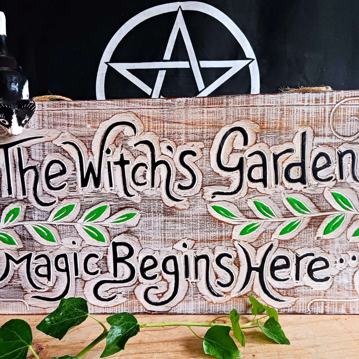 This solid wooden plaque has been hand etched and painted with the inscription: "The Witch's Garden. Magic Begins Here."