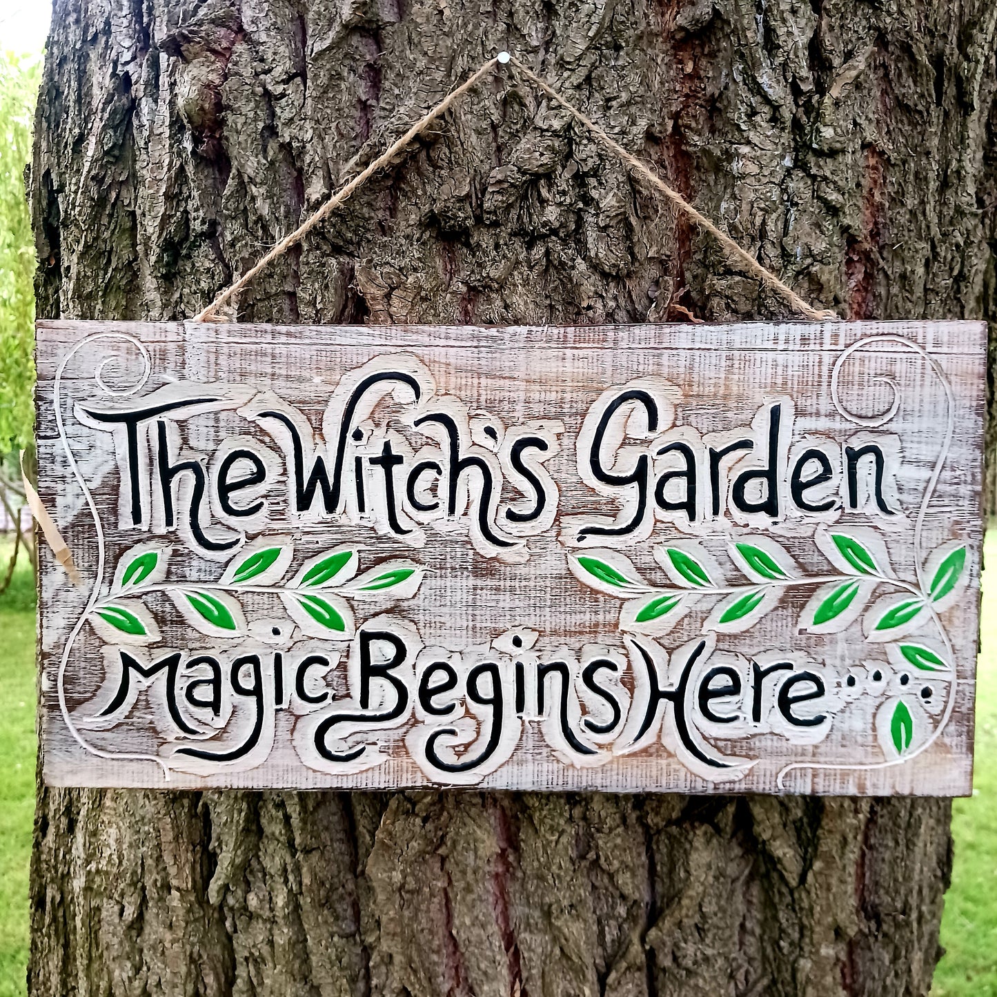 This solid wooden plaque has been hand etched and painted with the inscription: "The Witch's Garden. Magic Begins Here."