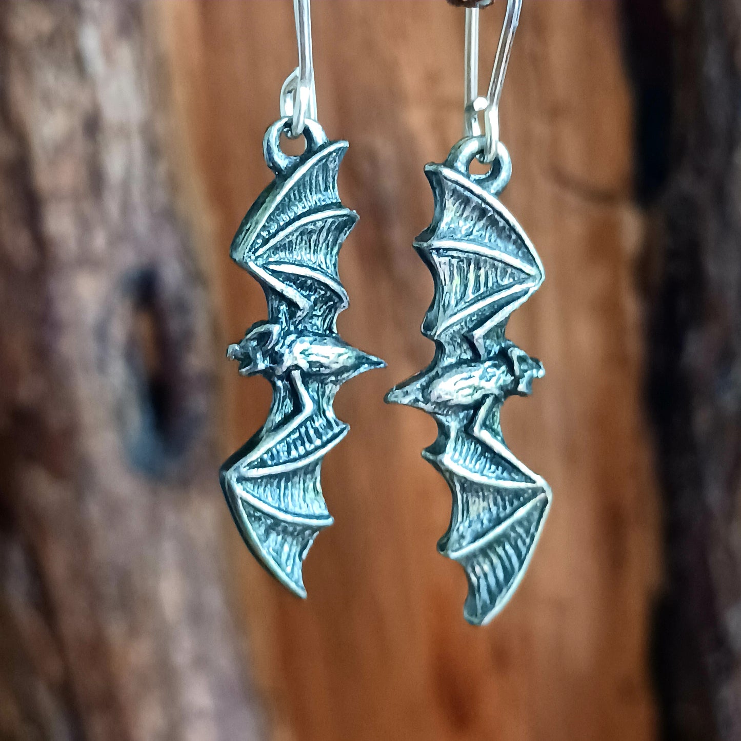 A pair of antique pewter, silver colour flying bat earrings. &nbsp;Creatures of the night frame your face!  Flying bats, silent and motionless, anticipate the dusk and the final vestige of light to be extinguished by the sunset - so, the raptors may play...