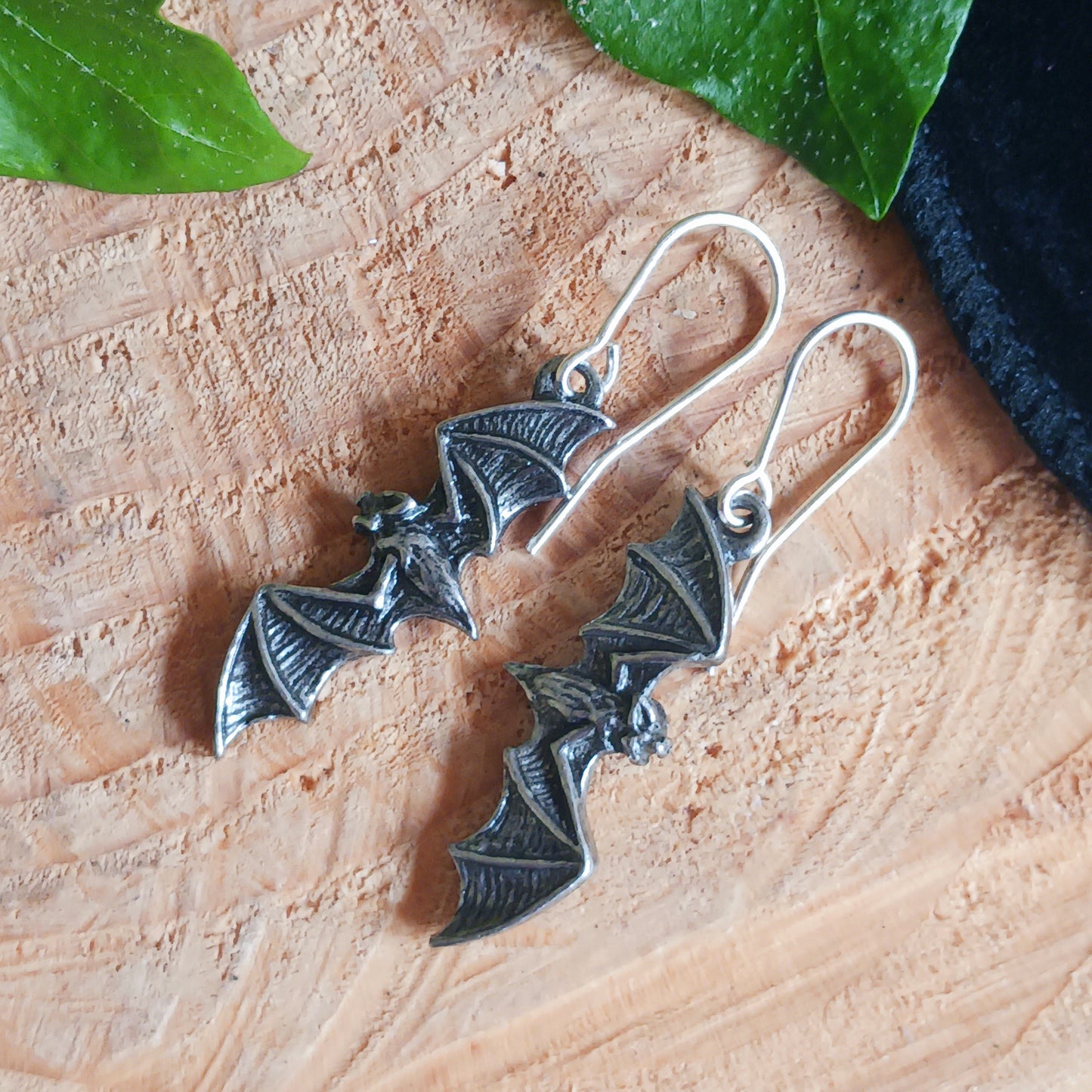 A pair of antique pewter, silver colour flying bat earrings. &nbsp;Creatures of the night frame your face!  Flying bats, silent and motionless, anticipate the dusk and the final vestige of light to be extinguished by the sunset - so, the raptors may play...