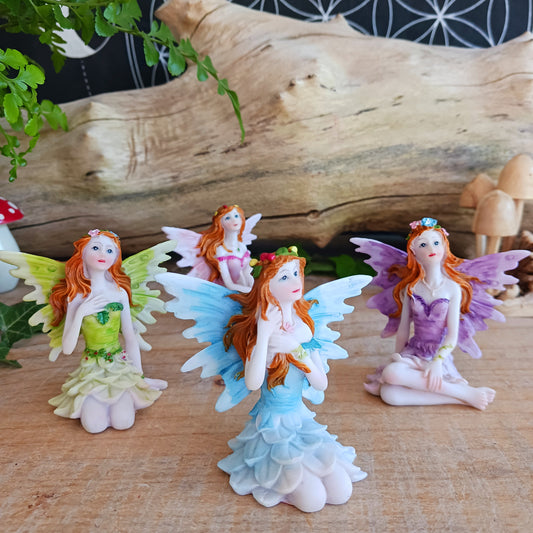 Kneeling on the ground, each of these adorable Fairies features a different colour and pose. They each have the sweetest faces and long wavy auburn hair.