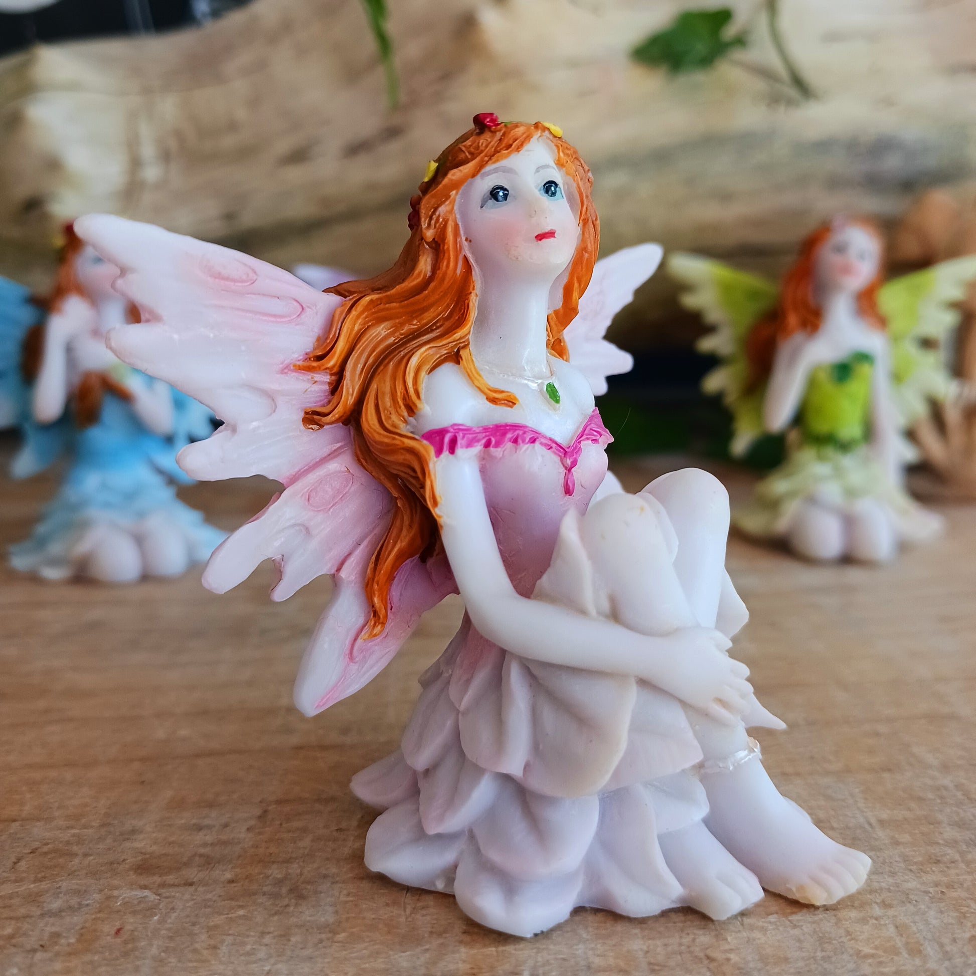 Kneeling on the ground, each of these adorable Fairies features a different colour and pose. They each have the sweetest faces and long wavy auburn hair.