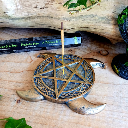 This Triple Moon Pentacle Incense Burner is cast in the finest resin before being given a high-quality bronze finish, shaped like the triple moon symbol, this piece lies on any flat surface. In the middle sits a pentagram with a central hole where you can place your favourite incense sticks.  The perfect gift for any spiritual follower.  Size: 15.5cm