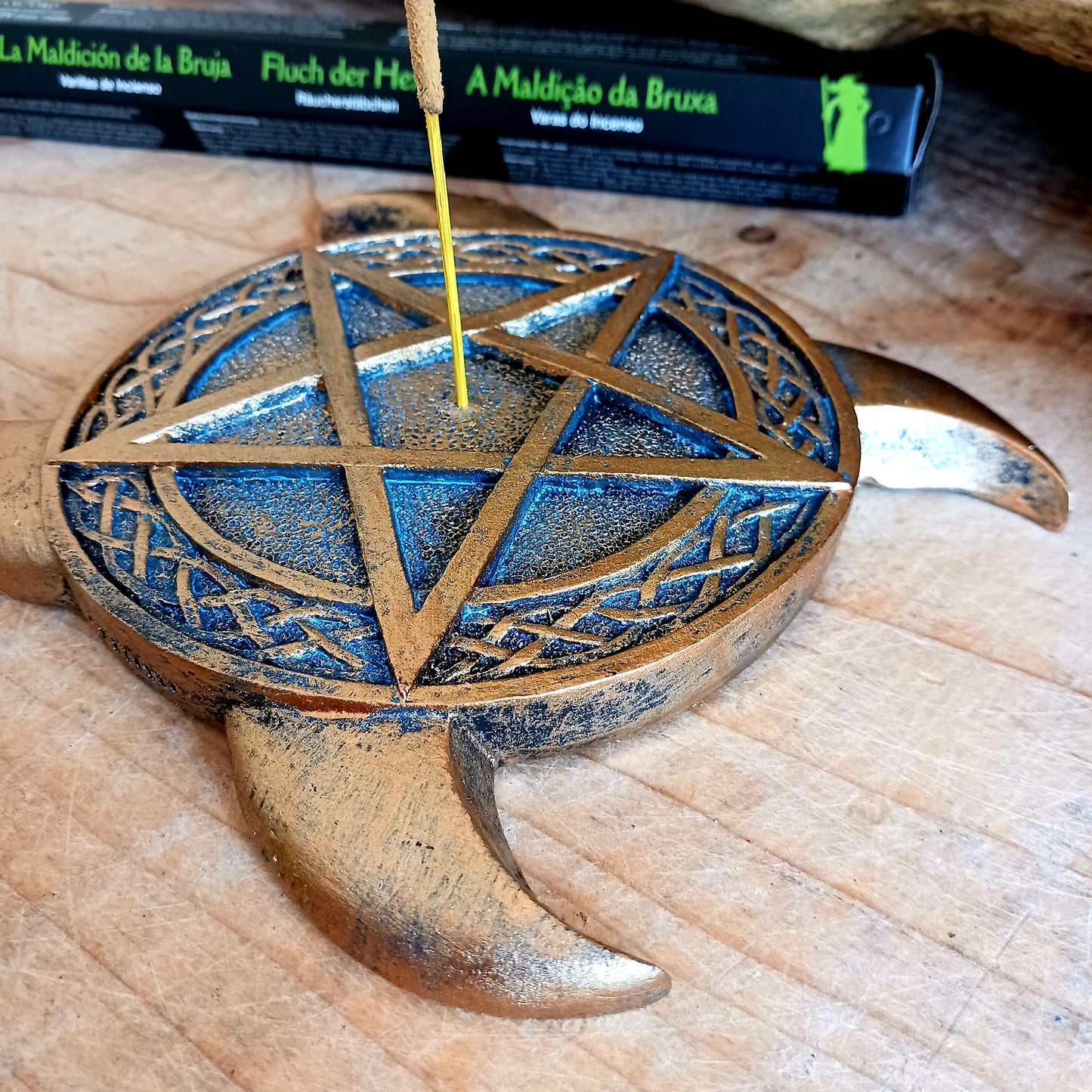 This Triple Moon Pentacle Incense Burner is cast in the finest resin before being given a high-quality bronze finish, shaped like the triple moon symbol, this piece lies on any flat surface. In the middle sits a pentagram with a central hole where you can place your favourite incense sticks.  The perfect gift for any spiritual follower.  Size: 15.5cm