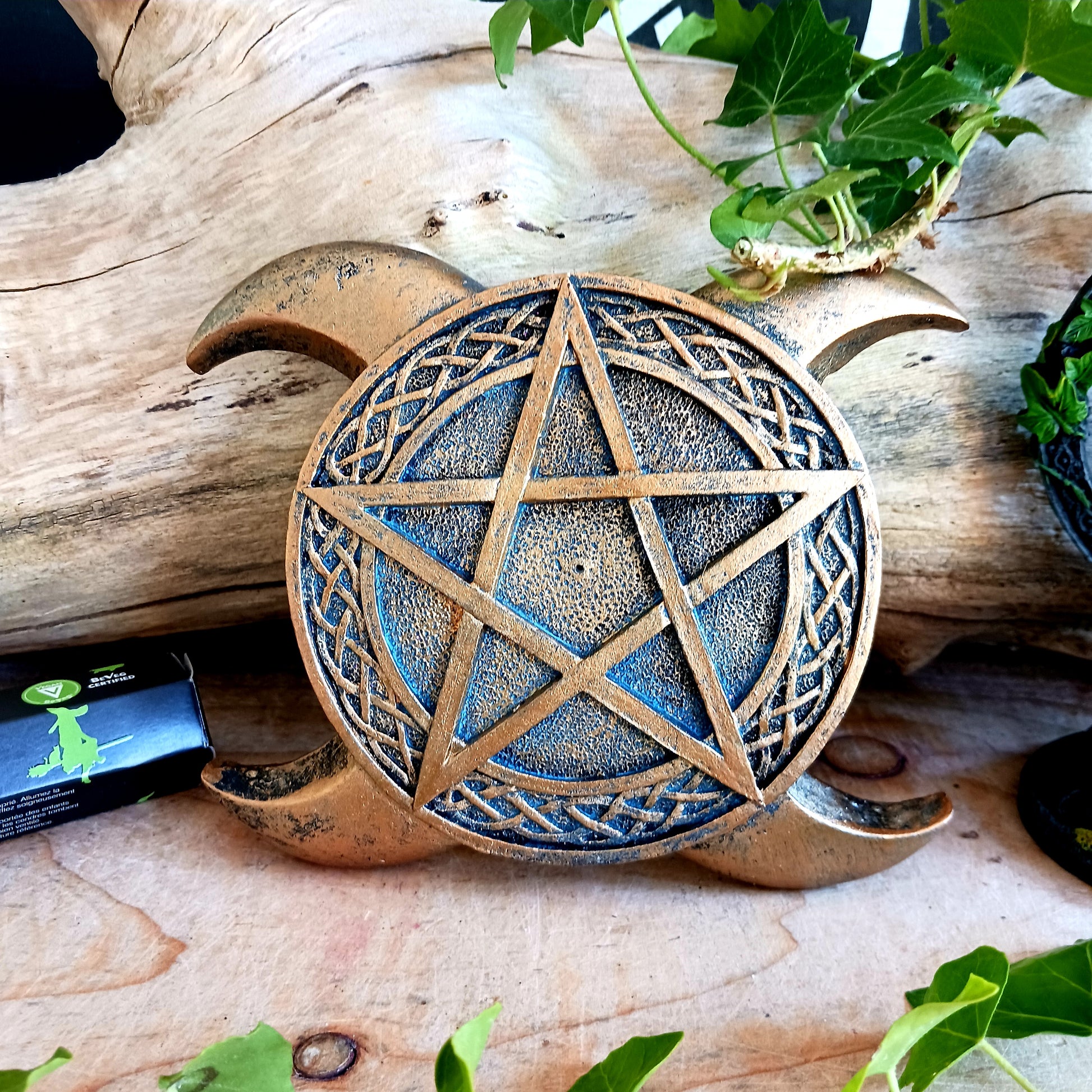 This Triple Moon Pentacle Incense Burner is cast in the finest resin before being given a high-quality bronze finish, shaped like the triple moon symbol, this piece lies on any flat surface. In the middle sits a pentagram with a central hole where you can place your favourite incense sticks.  The perfect gift for any spiritual follower.  Size: 15.5cm