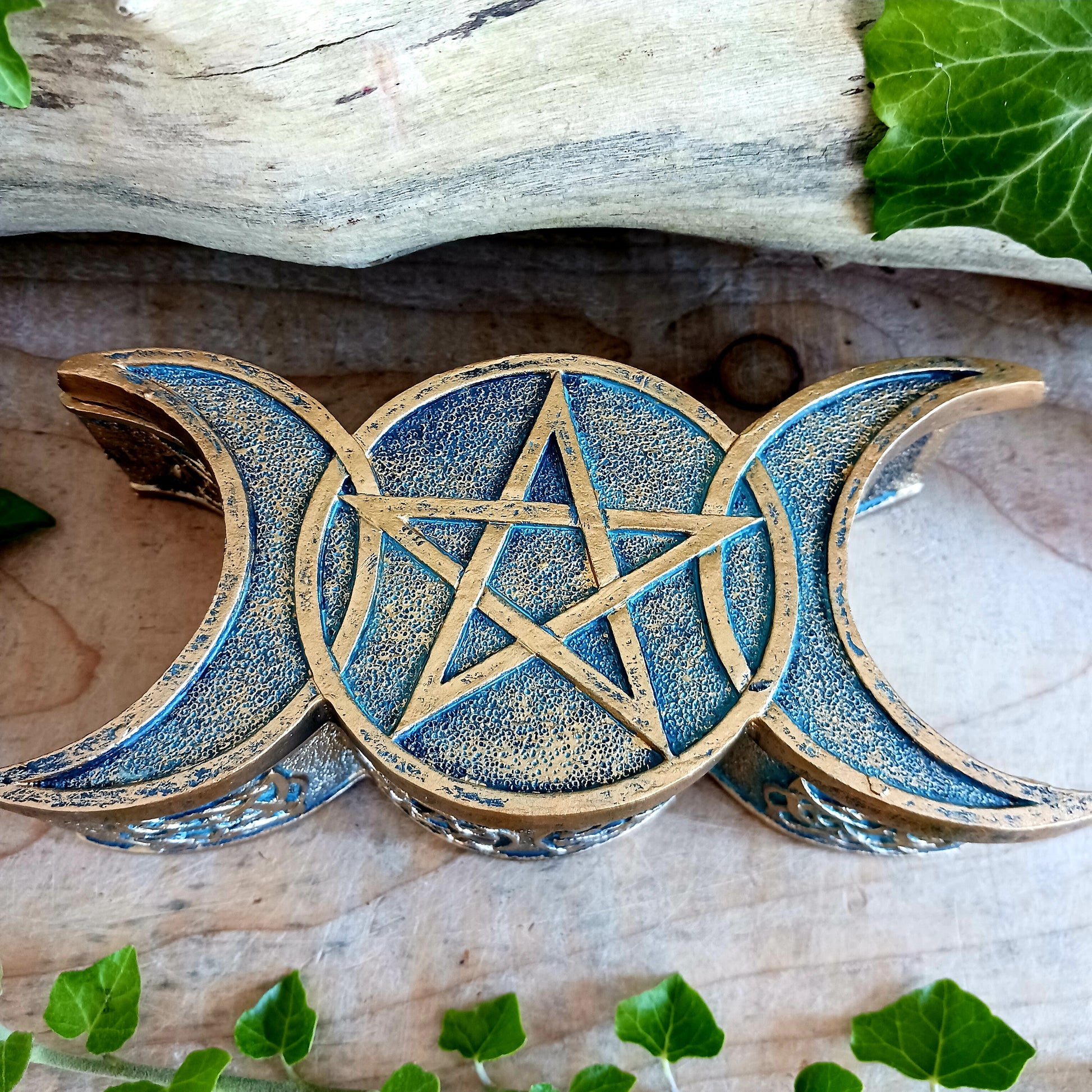 Whether you're seeking a unique storage solution or a decorative piece infused with spiritual symbolism, this Triple Moon Trinket Box is the perfect choice.  Embrace the lunar energy and its transformative power as you entrust your treasures to this enchanting box. Let it become a cherished part of your daily rituals, a tangible reminder of the cycles of life, and a symbol of the magic that resides within you.  Cast in high-quality resin before being expertly finished in bronze.  Size: 18.5cm