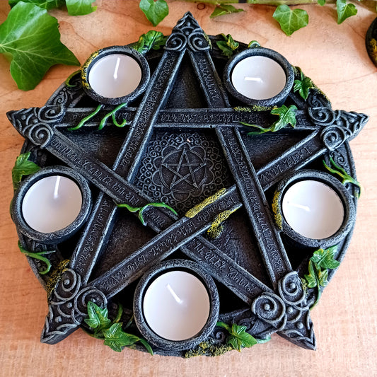 Wreathed in ivy and lichen, this tealight holder - created by Nemesis Now - is perfect for illuminating your home in more ways than one.  Cast in the highest quality resin, Celtic patterning and alchemist symbols reinforce the magic, while within the centre of the pentagram is another, smaller pentagram.  Holding 5 tealights, this piece is perfect for both lighting and ritual use, and is sure to make a stunning centre piece of any room.