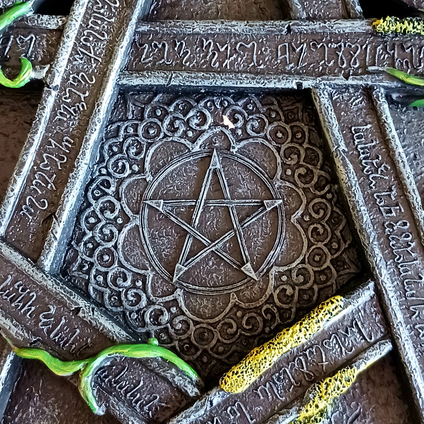 Wreathed in ivy and lichen, this tealight holder - created by Nemesis Now - is perfect for illuminating your home in more ways than one.  Cast in the highest quality resin, Celtic patterning and alchemist symbols reinforce the magic, while within the centre of the pentagram is another, smaller pentagram.  Holding 5 tealights, this piece is perfect for both lighting and ritual use, and is sure to make a stunning centre piece of any room.