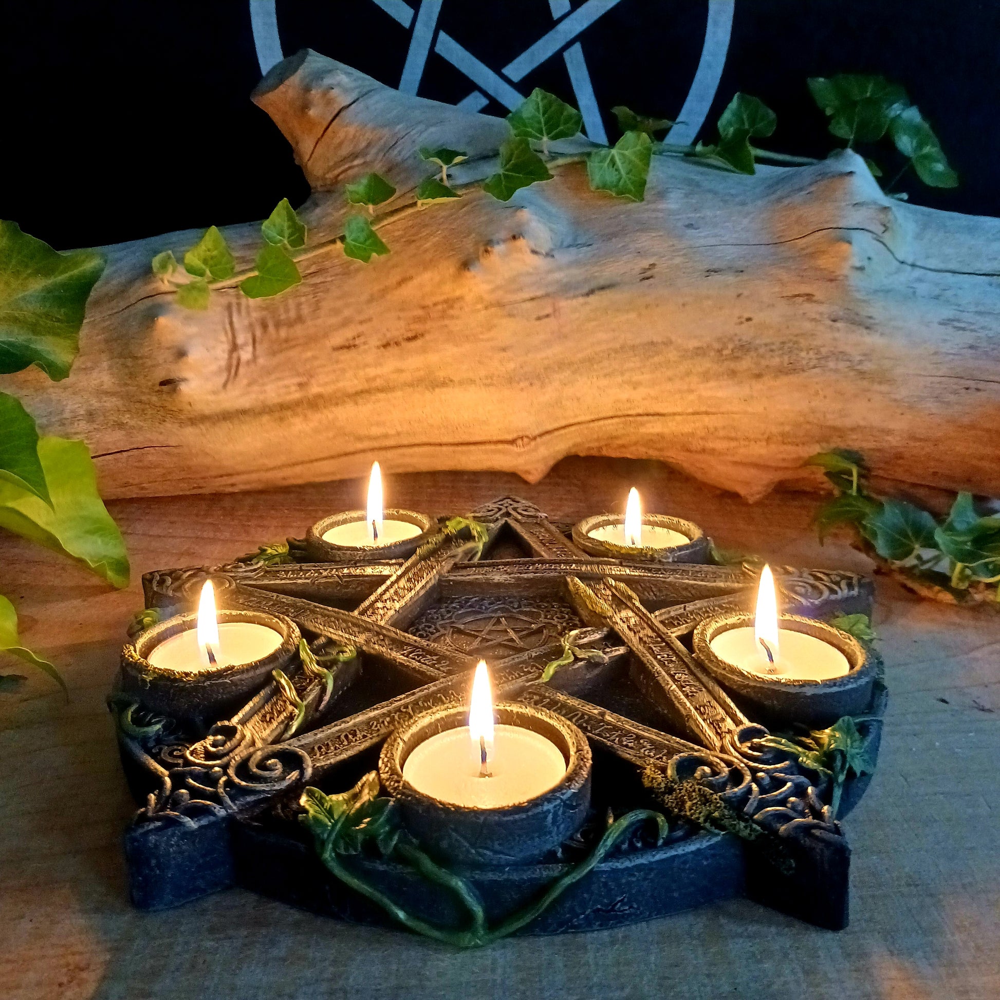 Wreathed in ivy and lichen, this tealight holder - created by Nemesis Now - is perfect for illuminating your home in more ways than one.  Cast in the highest quality resin, Celtic patterning and alchemist symbols reinforce the magic, while within the centre of the pentagram is another, smaller pentagram.  Holding 5 tealights, this piece is perfect for both lighting and ritual use, and is sure to make a stunning centre piece of any room.