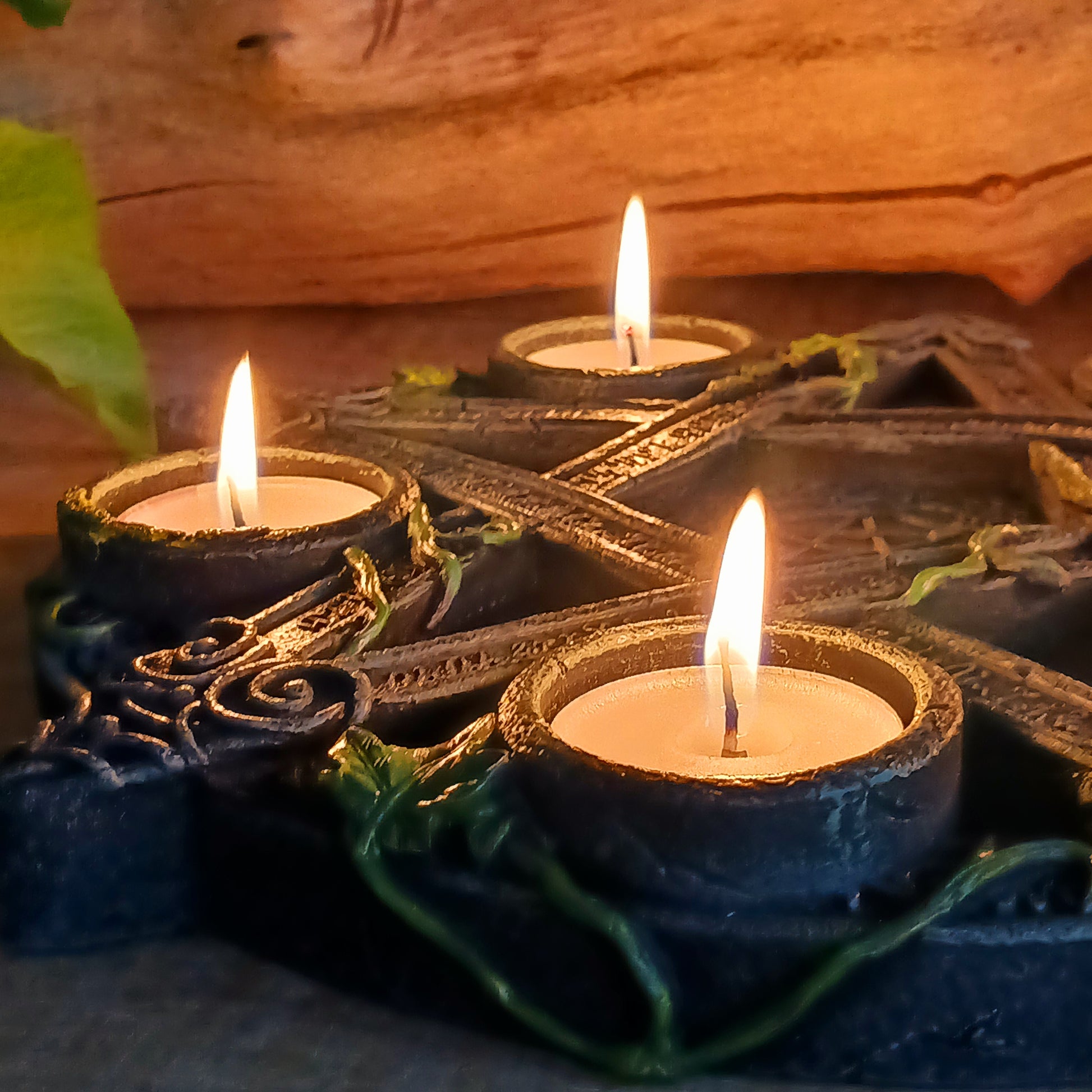 Wreathed in ivy and lichen, this tealight holder - created by Nemesis Now - is perfect for illuminating your home in more ways than one.  Cast in the highest quality resin, Celtic patterning and alchemist symbols reinforce the magic, while within the centre of the pentagram is another, smaller pentagram.  Holding 5 tealights, this piece is perfect for both lighting and ritual use, and is sure to make a stunning centre piece of any room.