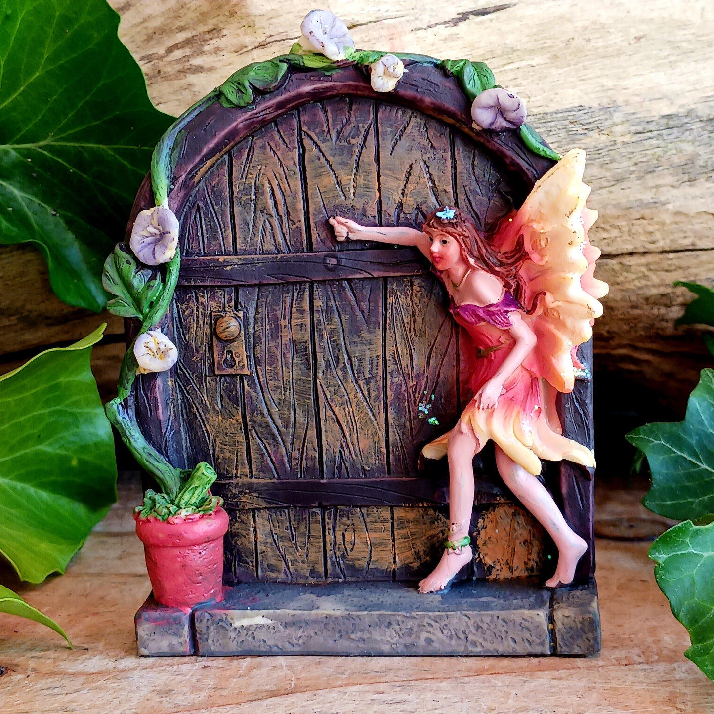 Two small fairy doors in two assorted designs. These fairy doors have sprinkles of glitter and are intricately designed. Perfect to welcome fairies into the home or garden.