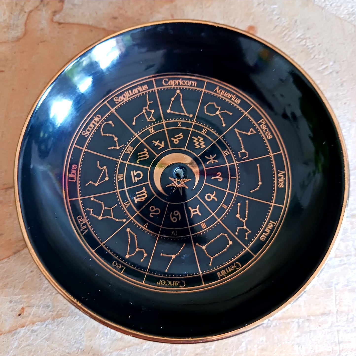 This beautiful black incense dish depicts the astrology wheel in intricate, gold effect detail for a premium look. The holder is thoughtfully designed to accommodate both incense sticks and cones, featuring a small hole in the centre for sticks and a flat stable surface suitable for burning cones. A gorgeous finishing touch for any home with celestial-inspired decor.