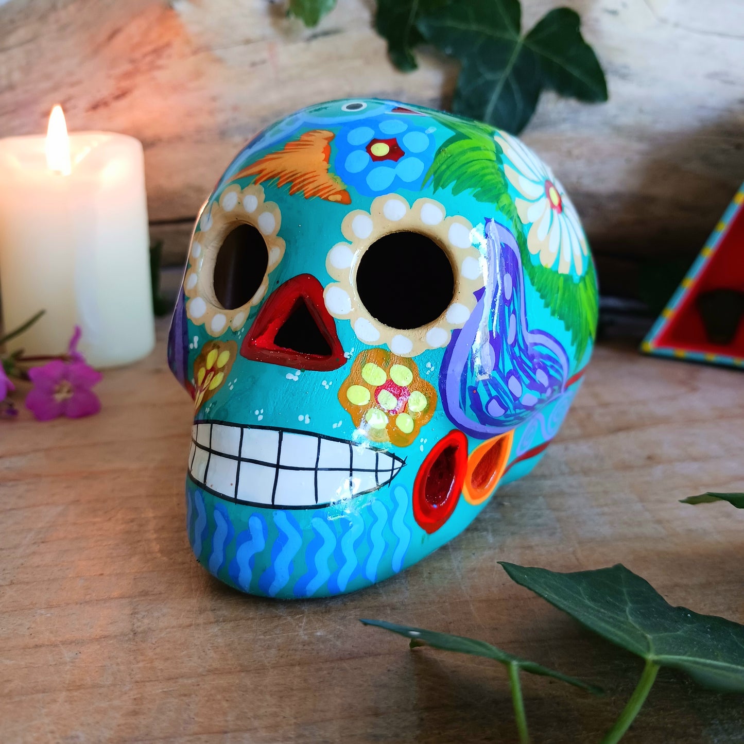 These fun ceramic sugar skull ornaments have been beautifully painted in bright colours and finished with a high shine glaze. They are a popular item during Día de Los Muertos or Day of the Dead festivities, held in Mexico every November to celebrate welcoming the souls of their deceased relatives back for a time of food, drink and celebration.