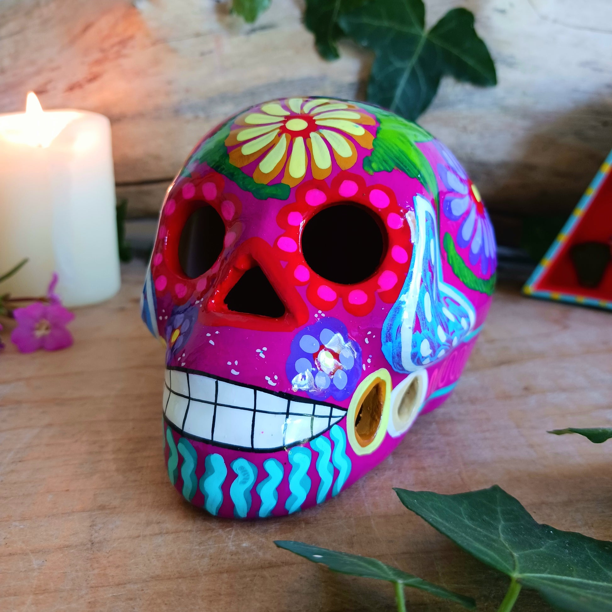 These fun ceramic sugar skull ornaments have been beautifully painted in bright colours and finished with a high shine glaze. They are a popular item during Día de Los Muertos or Day of the Dead festivities, held in Mexico every November to celebrate welcoming the souls of their deceased relatives back for a time of food, drink and celebration.