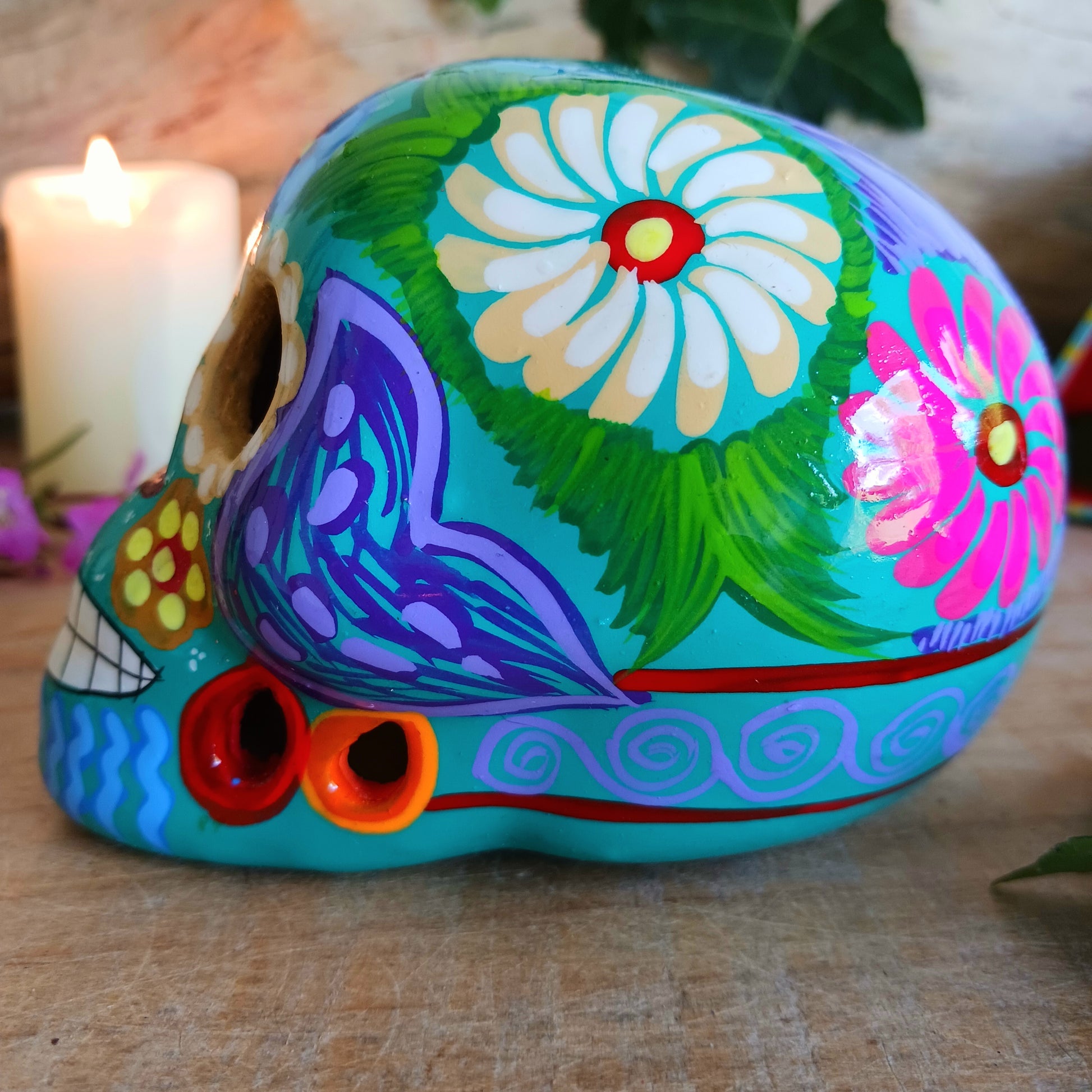 These fun ceramic sugar skull ornaments have been beautifully painted in bright colours and finished with a high shine glaze. They are a popular item during Día de Los Muertos or Day of the Dead festivities, held in Mexico every November to celebrate welcoming the souls of their deceased relatives back for a time of food, drink and celebration.