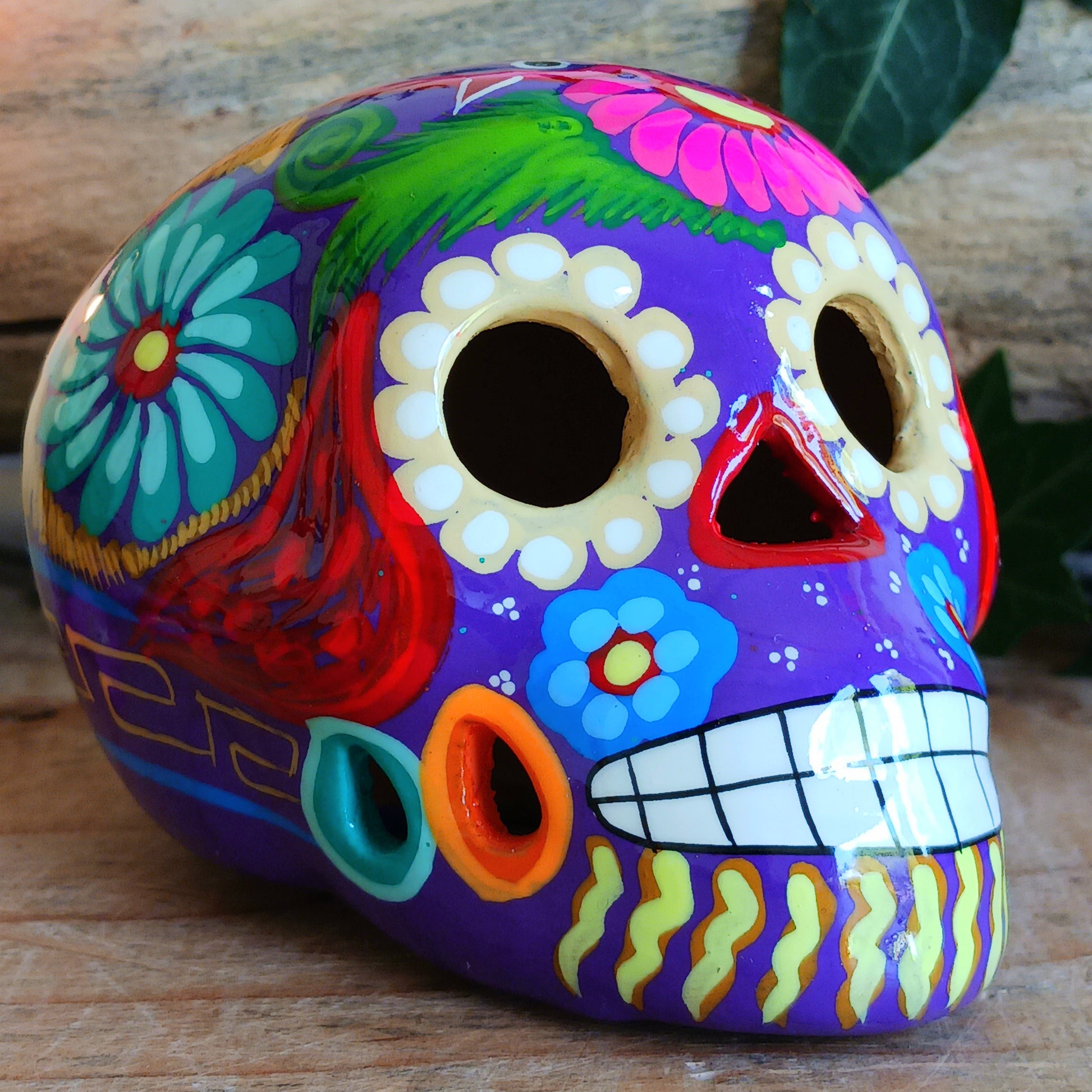 These fun ceramic sugar skull ornaments have been beautifully painted in bright colours and finished with a high shine glaze. They are a popular item during Día de Los Muertos or Day of the Dead festivities, held in Mexico every November to celebrate welcoming the souls of their deceased relatives back for a time of food, drink and celebration.