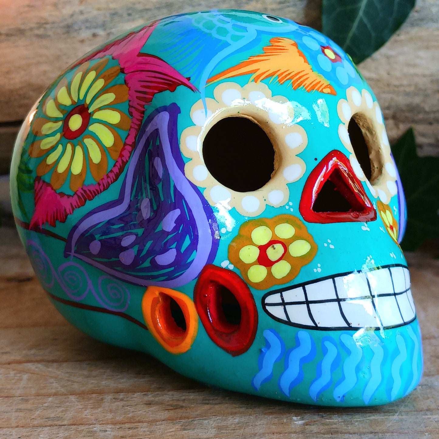 These fun ceramic sugar skull ornaments have been beautifully painted in bright colours and finished with a high shine glaze. They are a popular item during Día de Los Muertos or Day of the Dead festivities, held in Mexico every November to celebrate welcoming the souls of their deceased relatives back for a time of food, drink and celebration.