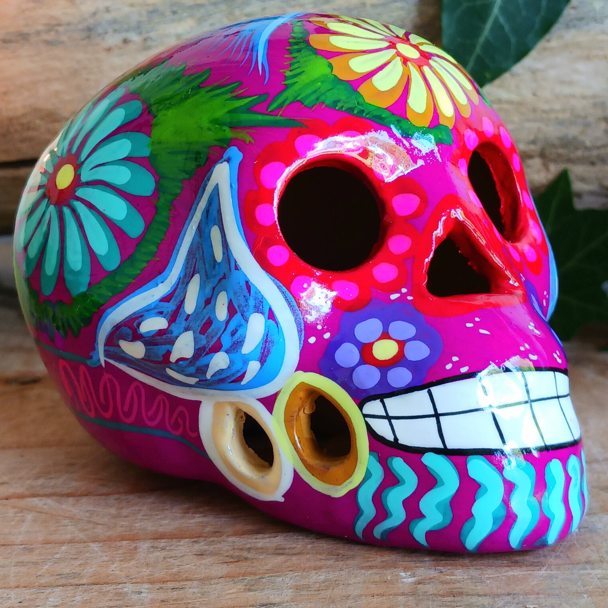 These fun ceramic sugar skull ornaments have been beautifully painted in bright colours and finished with a high shine glaze. They are a popular item during Día de Los Muertos or Day of the Dead festivities, held in Mexico every November to celebrate welcoming the souls of their deceased relatives back for a time of food, drink and celebration.