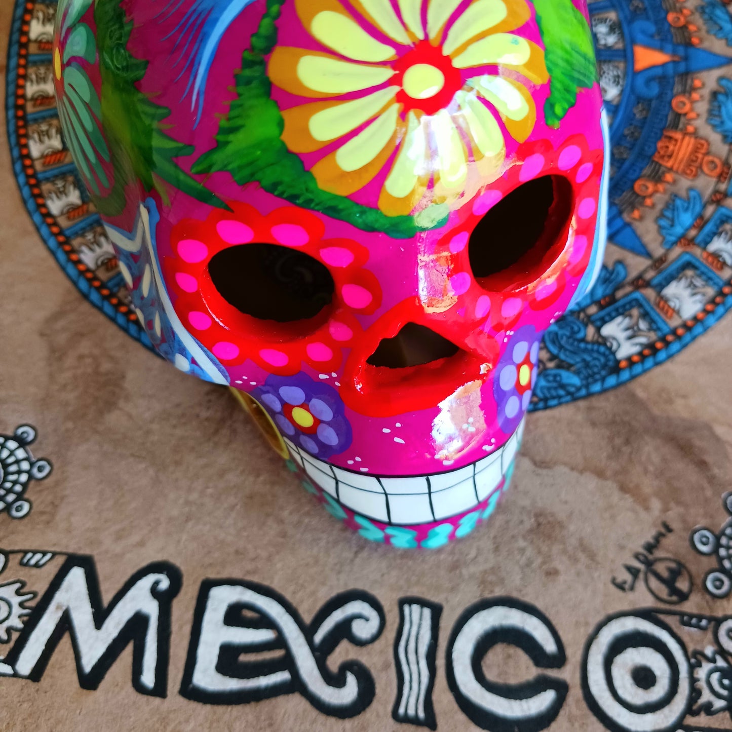 These fun ceramic sugar skull ornaments have been beautifully painted in bright colours and finished with a high shine glaze. They are a popular item during Día de Los Muertos or Day of the Dead festivities, held in Mexico every November to celebrate welcoming the souls of their deceased relatives back for a time of food, drink and celebration.