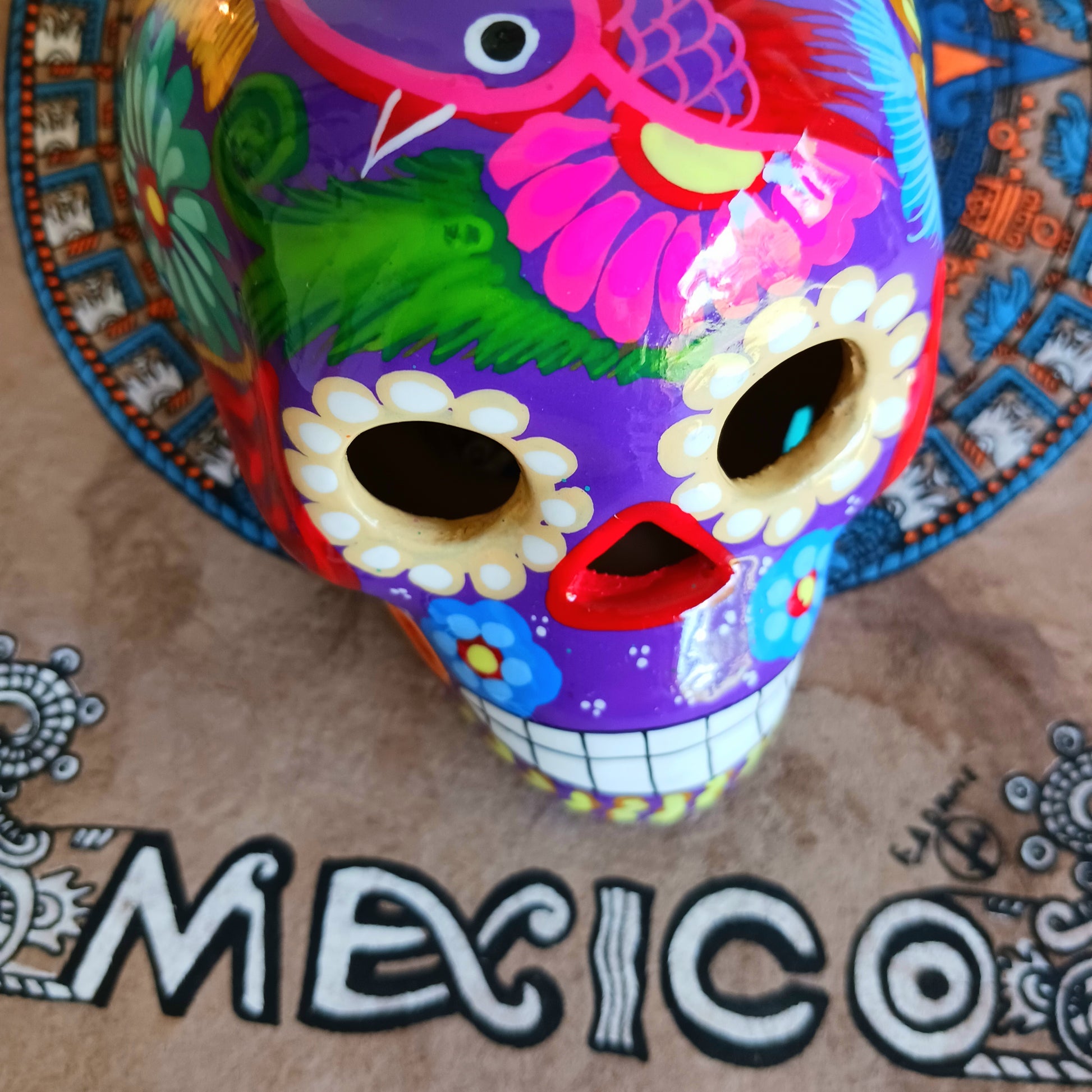 These fun ceramic sugar skull ornaments have been beautifully painted in bright colours and finished with a high shine glaze. They are a popular item during Día de Los Muertos or Day of the Dead festivities, held in Mexico every November to celebrate welcoming the souls of their deceased relatives back for a time of food, drink and celebration.