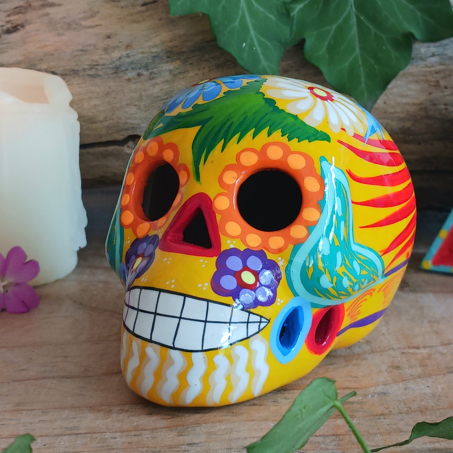 These fun ceramic sugar skull ornaments have been beautifully painted in bright colours and finished with a high shine glaze. They are a popular item during Día de Los Muertos or Day of the Dead festivities, held in Mexico every November to celebrate welcoming the souls of their deceased relatives back for a time of food, drink and celebration.