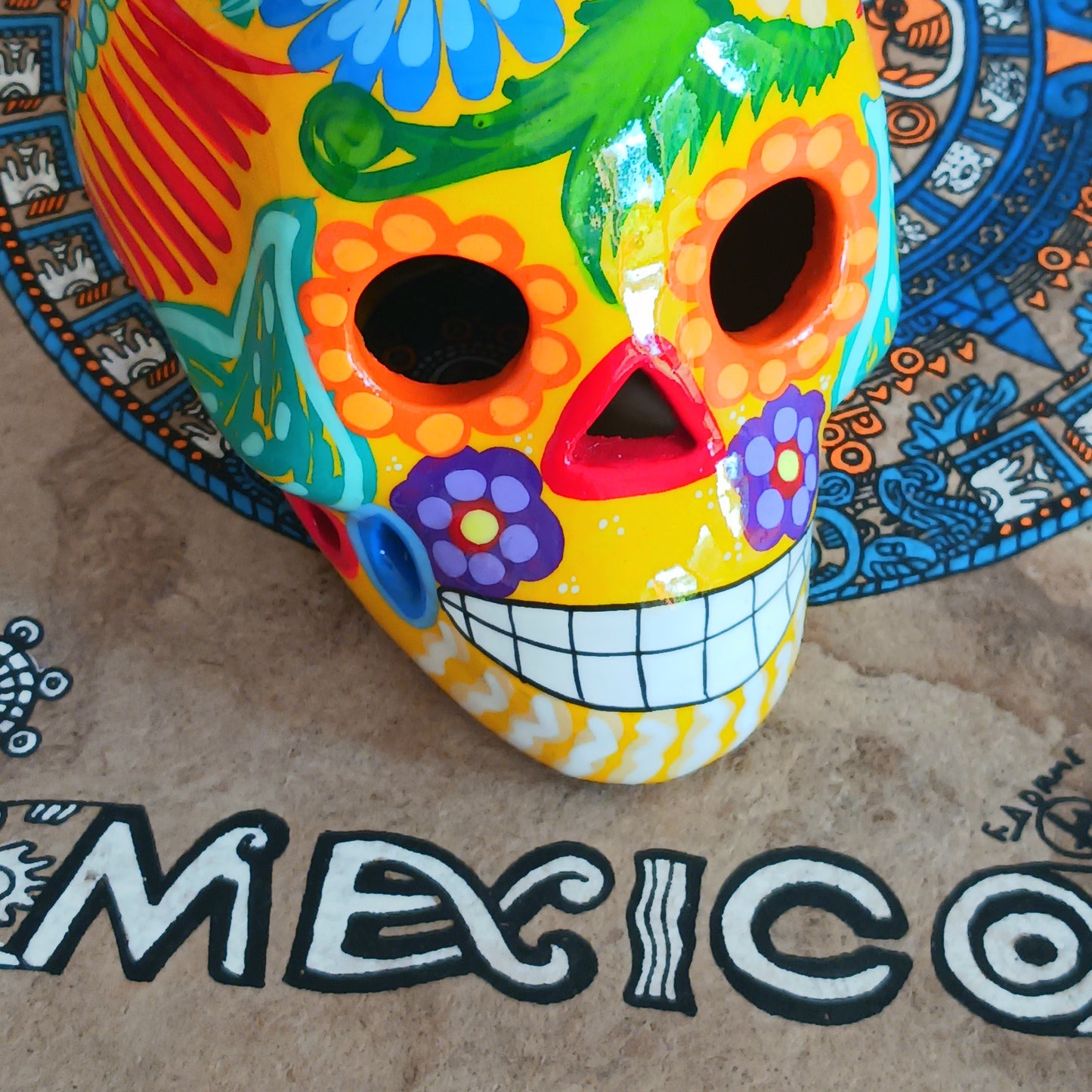 These fun ceramic sugar skull ornaments have been beautifully painted in bright colours and finished with a high shine glaze. They are a popular item during Día de Los Muertos or Day of the Dead festivities, held in Mexico every November to celebrate welcoming the souls of their deceased relatives back for a time of food, drink and celebration.